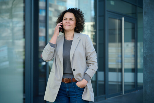 Woman on the phone outside a building.