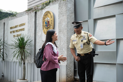 Female Securitas receptionist assists a male visitor in an office building. 