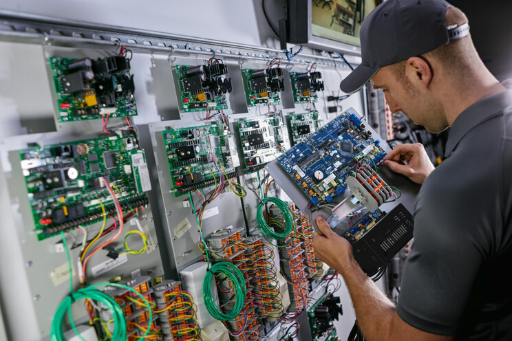 Electronic security employee installing a security system
