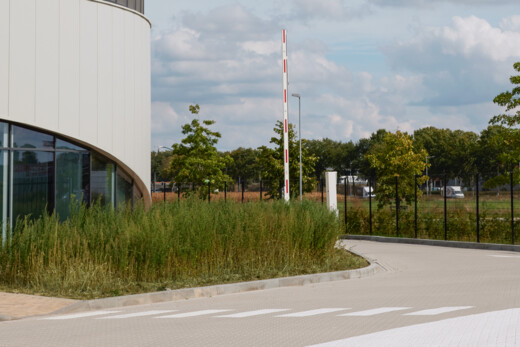 Outside of a commercial building with a security barrier in the distance