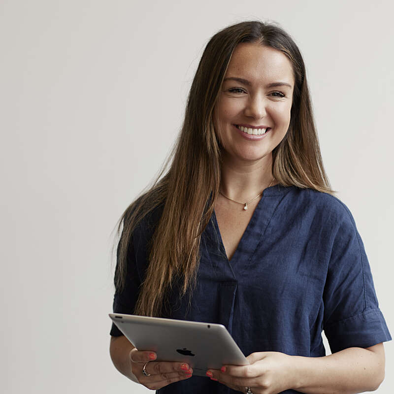 Smiling female Securitas employee with tablet