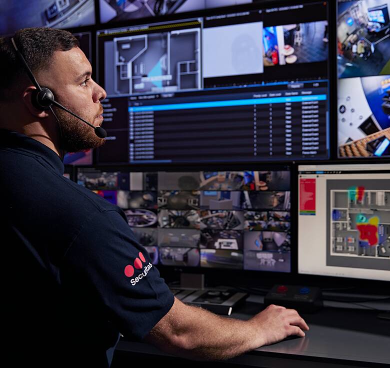 Securitas SOC operator monitoring intrusions and video alarm activations on multiple screens within the Securitas SOC.