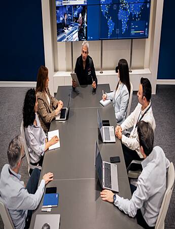 Security professionals analyzing security intelligence, operational data, and monitoring systems to support intelligent security services.