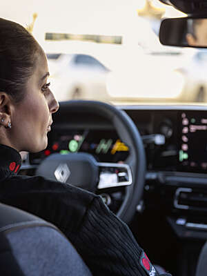 Female Securitas guard looking at a monitor in a car.