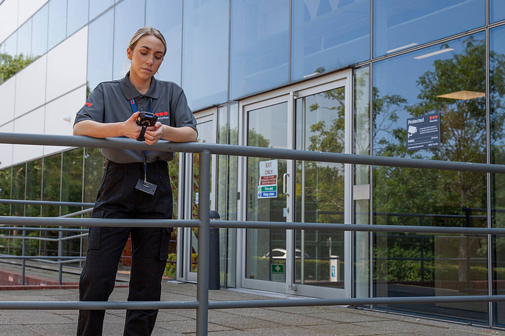 Female mobile patrol officer completing a MySecuritas report after patrolling the client’s premises