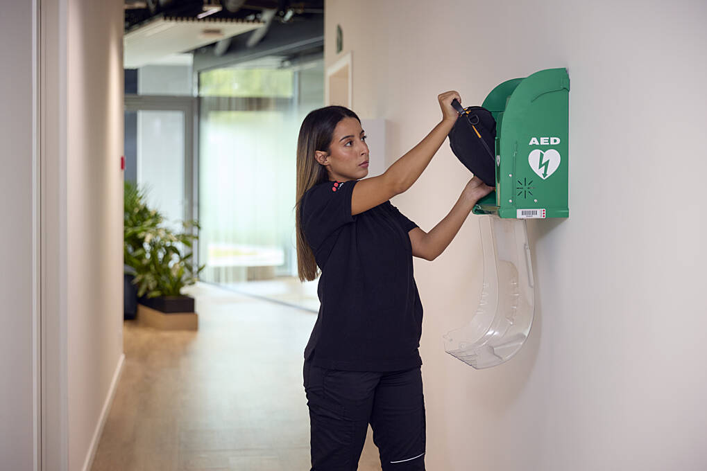 Female security guard inspecting a first aid kit.