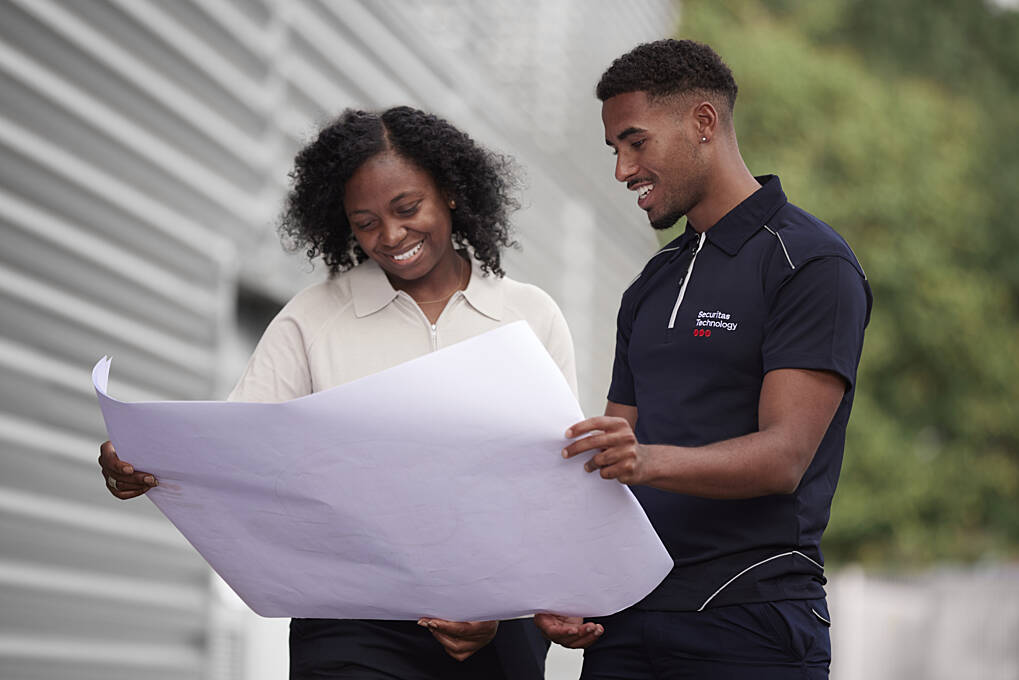 Securitas Technology employee and client looking at plans