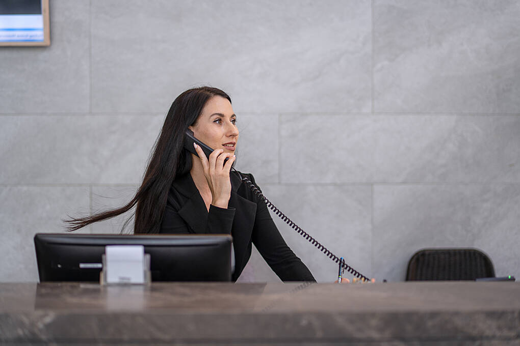 Female receptionist on the phone.