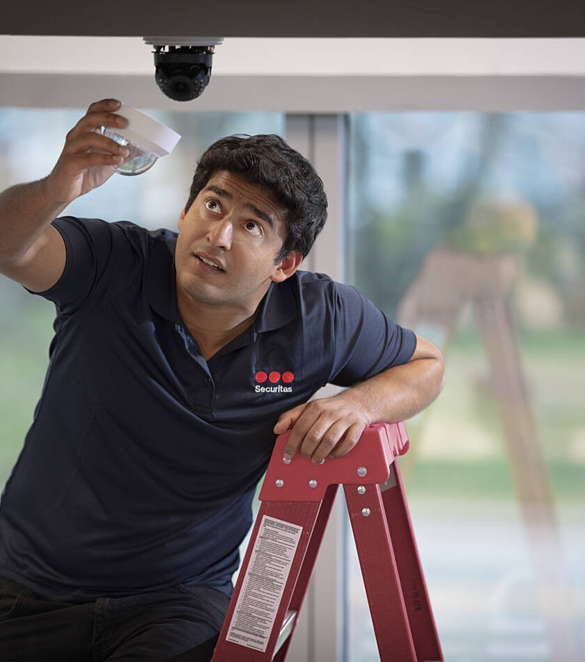 Securitas Ireland engineer carrying out CCTV maintenance at a client’s office building
