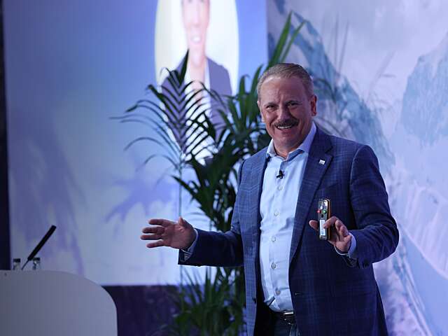 Tony Byerly speaking on stage.