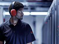AI generated image of male Securitas guard in a data center.
