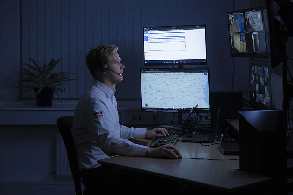 Male remote guarding Securitas guard surveilling business sites.