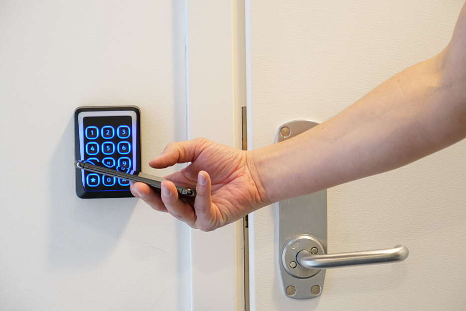 Person unlocking the door with mobile phone