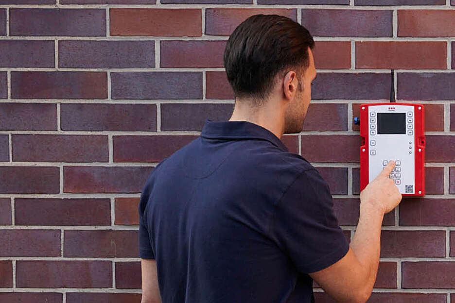 Fire alarm control panel with signals being monitored in a security operations centre