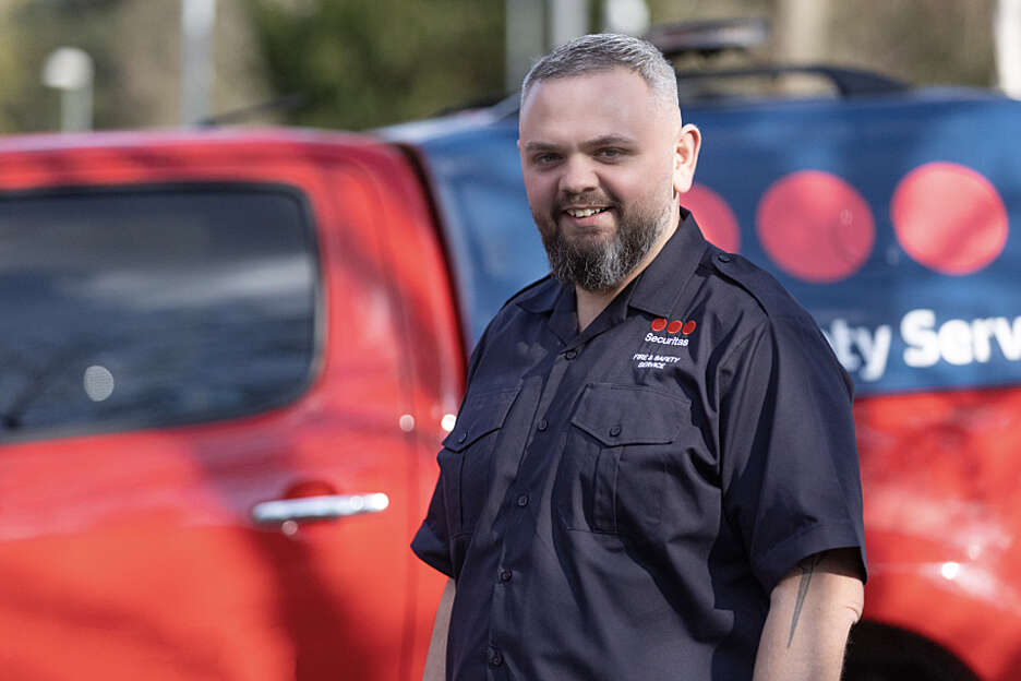 Male security officer stood outside fire van