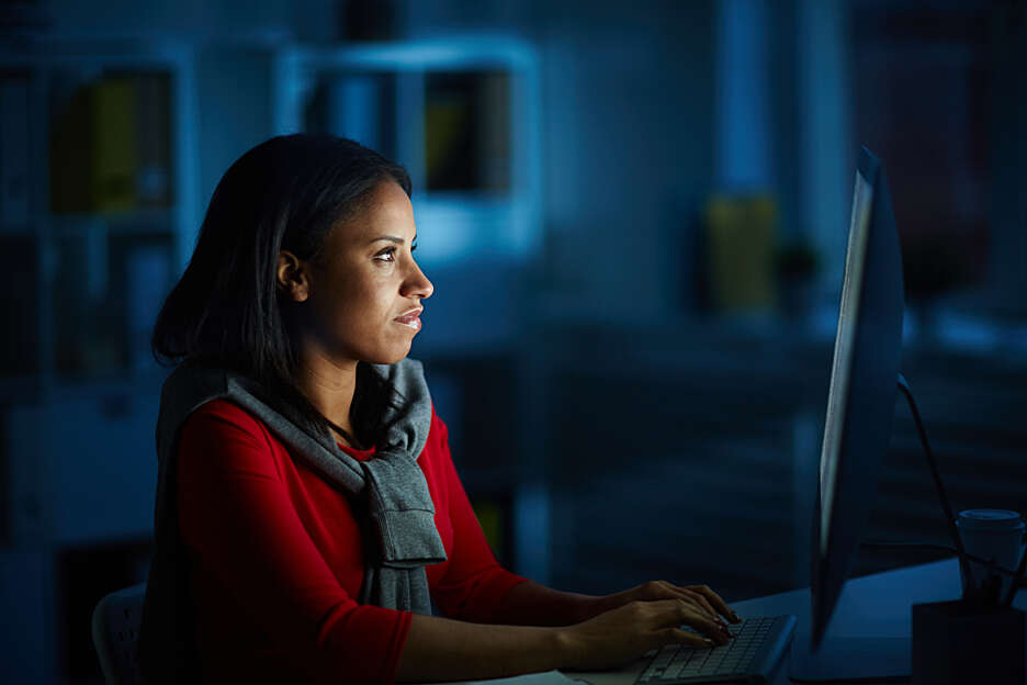 RIC worker on her computer