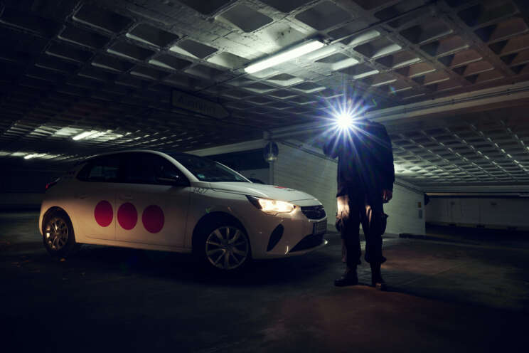 Securitas patrol guard walking through a dimly lit area during a nighttime patrol