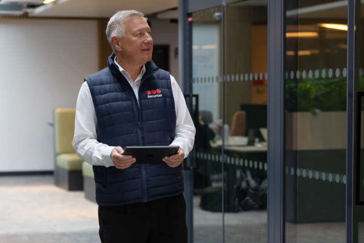 Male walking through building with an Ipad