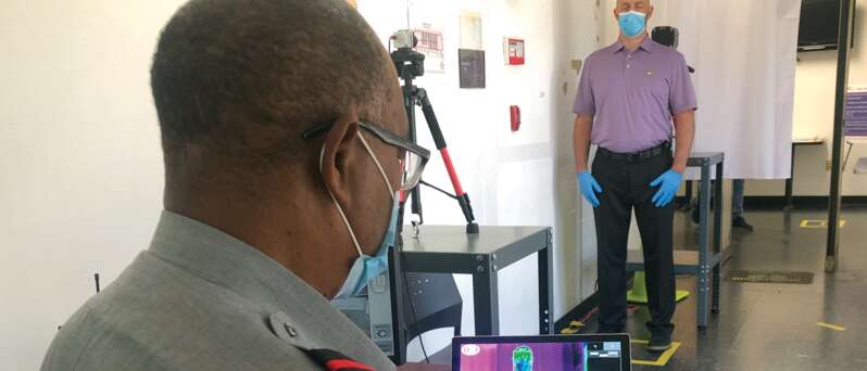 Officer using thermo imaging for access control